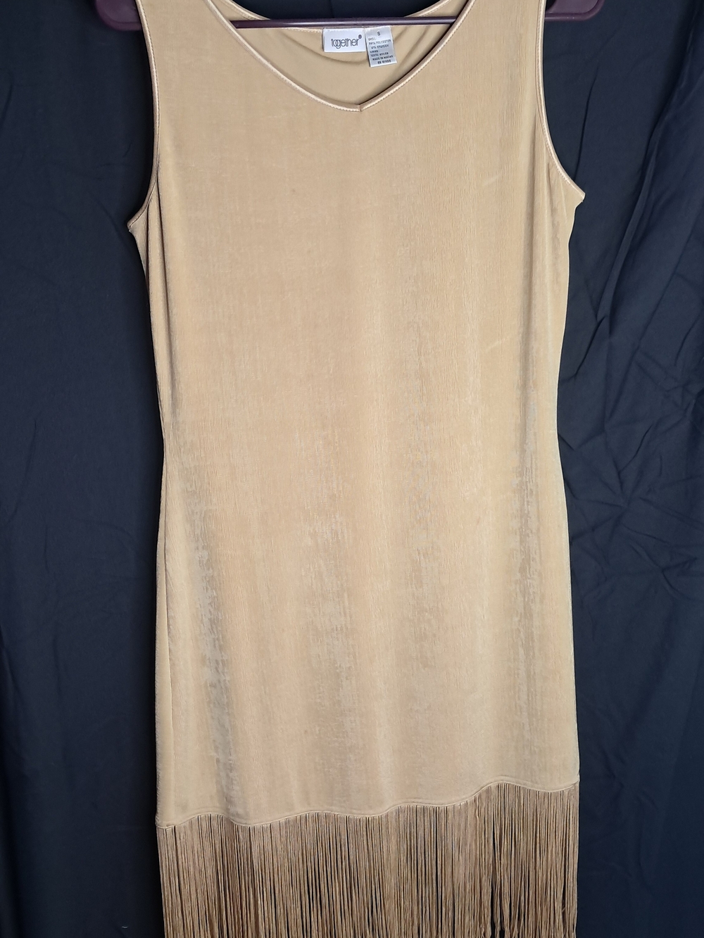 This is a Together brand vintage sleeveless golden midi dress featuring a distin